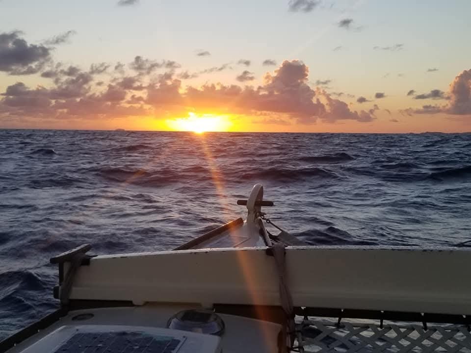 Dramatic golden sunset over open ocean from the Mahiya bow