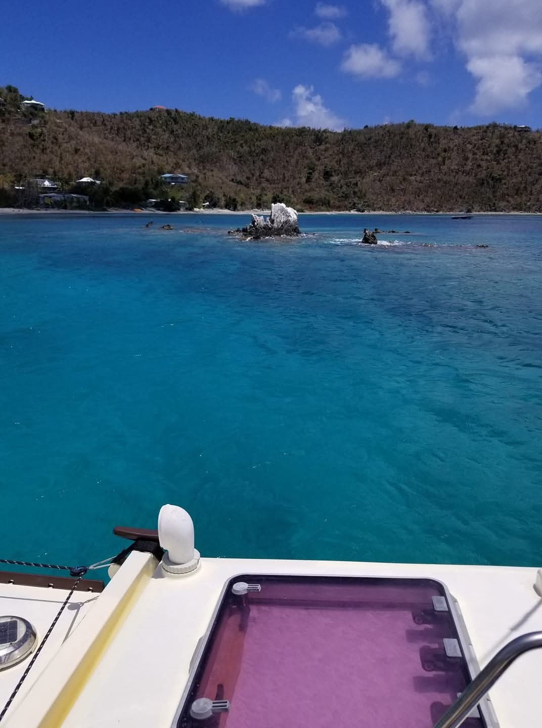 Crystal turquoise cove from the Mahiya bow with rocky Virgin Islands coastline