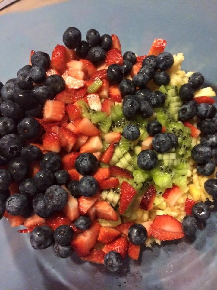 Fresh fruit salad bowl with blueberries, strawberries, kiwi and pineapple — snacks served on the Mahiya