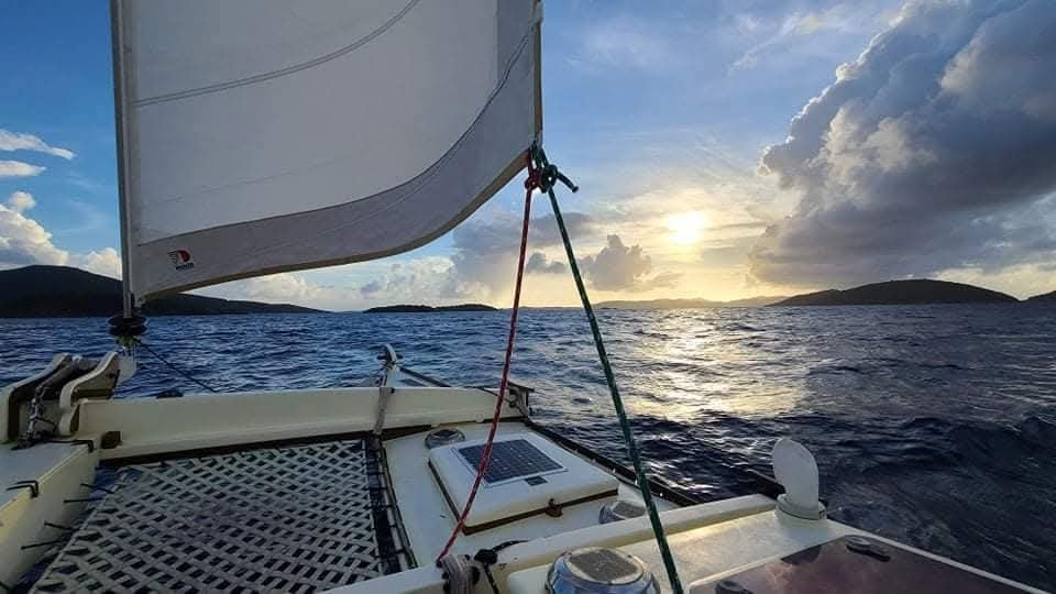 View from the Mahiya catamaran deck sailing toward a stunning sunset